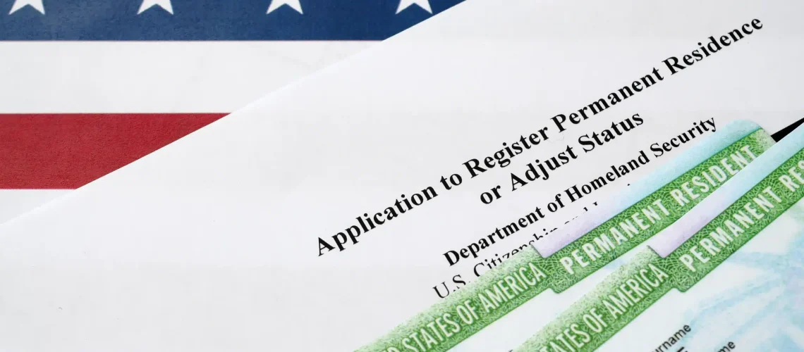 i-485-application-to-register-permanent-residence-or-adjust-status-form-and-green-card-from-dv-lottery-lies-on-united-states-flag-from-department-of-homeland-security-photo 1